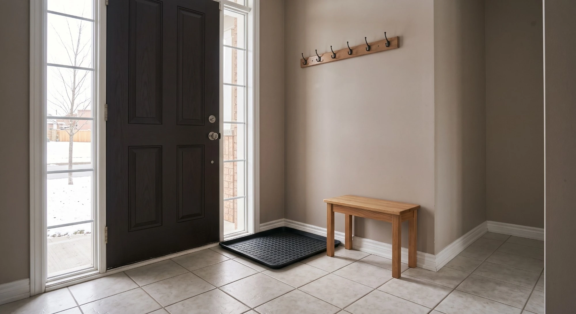 Illustration: a tiled front entry with a boot tray, a wooden bench and coat hooks
